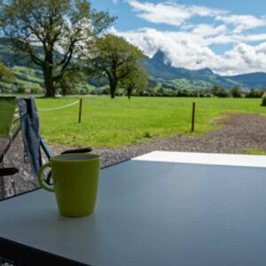 Camping table and chairs in the Switzerland Alps. Great view. Outdoor camping concept