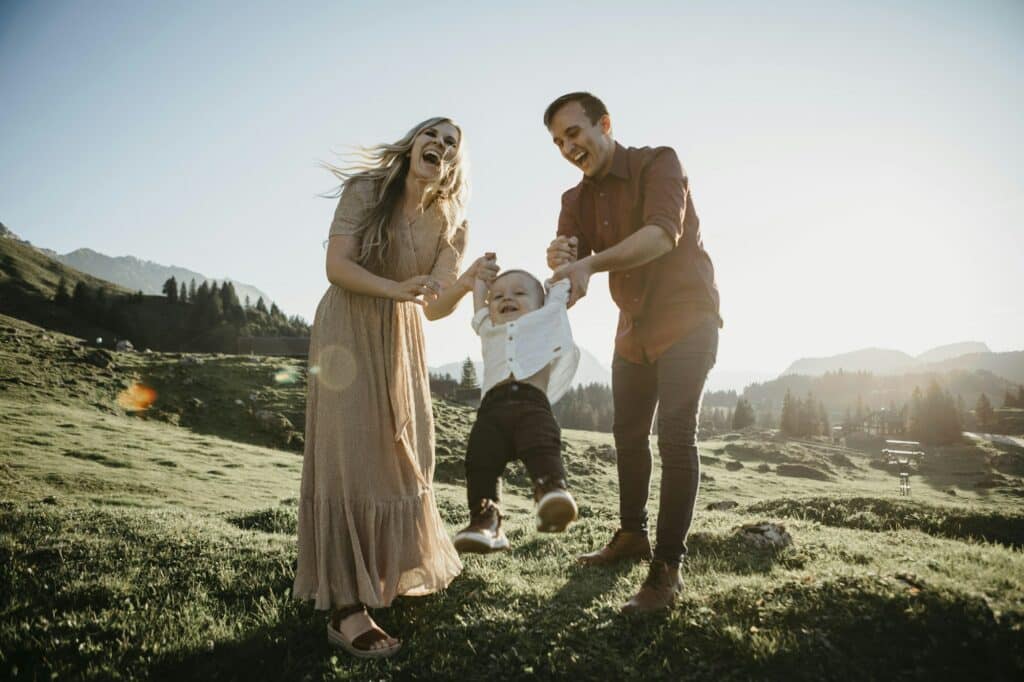 Happy family playing with little son on a hiking trip, Schwaegalp, Nesslau, Switzerland