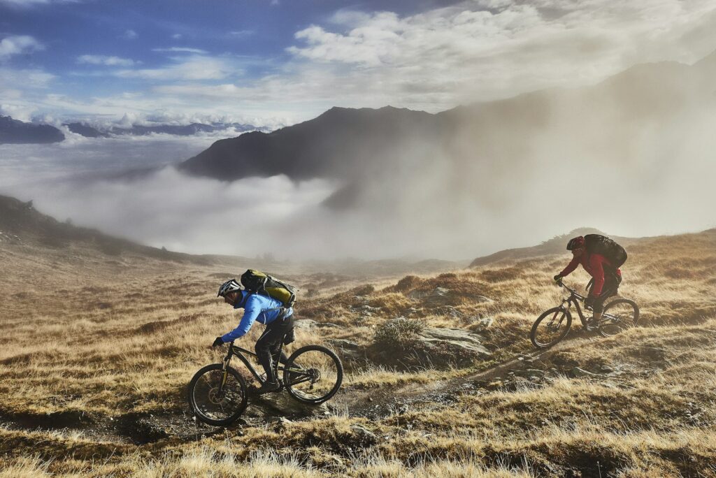 Mature men mountain biking, Valais, Switzerland